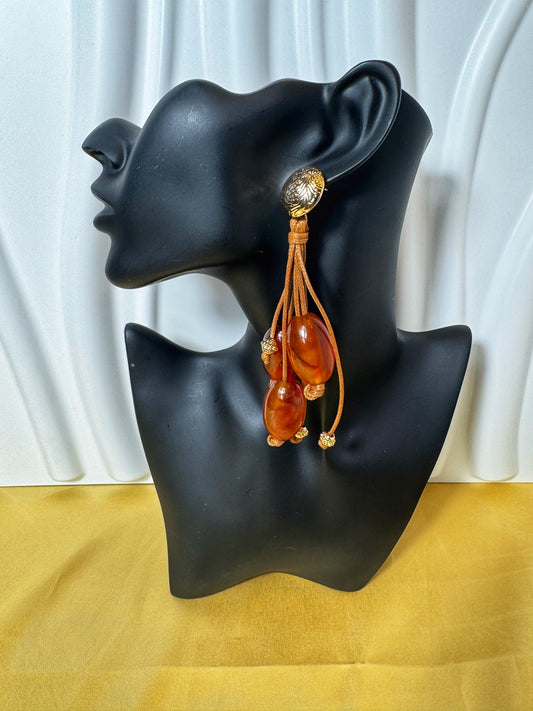 Stylish Caramel Dripping Earrings featuring amber beads and gold accents, perfect for any elegant outfit.