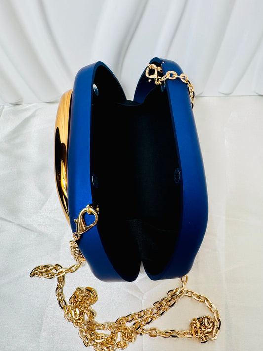 Stylish Retro Clutch in blue with gold chain, perfect for adding a vintage touch to any outfit.